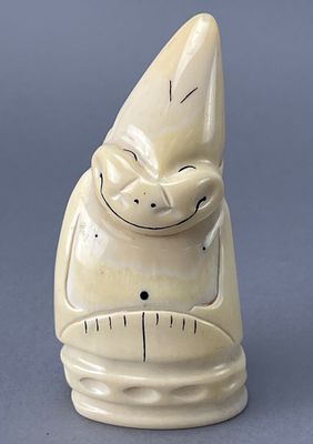 Carved Decorative Figure with Smiling Face. Carved Walrus tusk Billiken figurine featuring a 