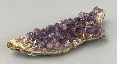 Amethyst Crystal Cluster on Rock Matrix. Amethyst crystal cluster on a rock matrix featuring 