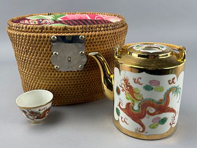 Porcelain Teapot and Teacup Set with Basket. Porcelain teapot and teacup set with wicker basket. 