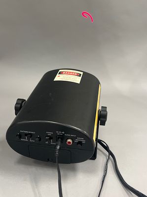 Laser Light Show Projector with Stand. Black cylindrical laser light show projector with a stand 