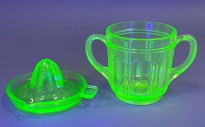 Uranium Glass Juicer and Handled Cup Set. Green uranium glass juicer with a reamer and a 