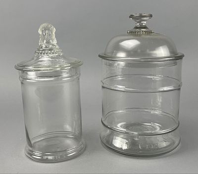 Set of Glass Apothecary Jars with Figural Lid. Set of two glass apothecary jars with lids. One 