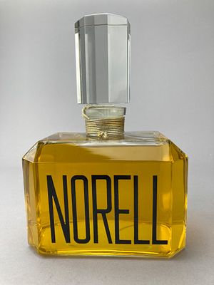 Large Norell Perfume Advertising Factice Bottle. Large-scale faceted rectangular glass bottle 
