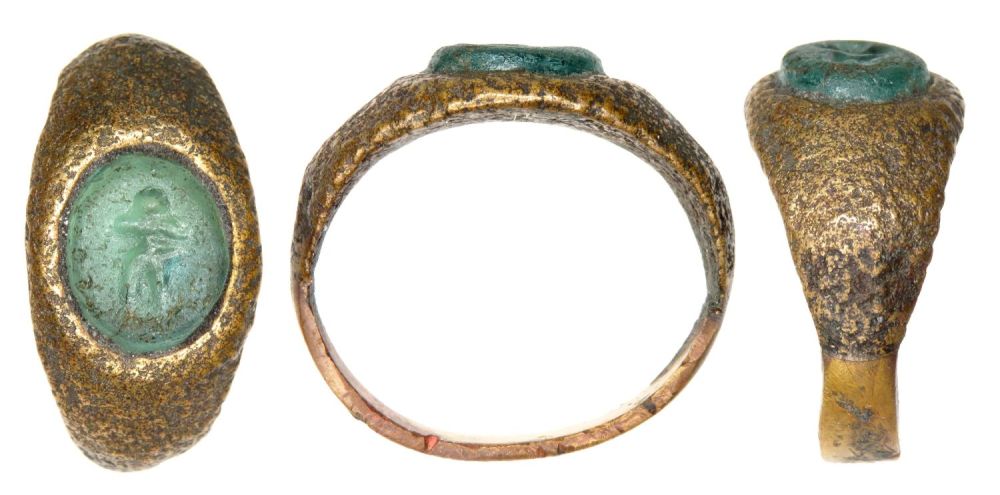 Lot 1030: Roman bronze ring with pale blue/green glass intaglio...