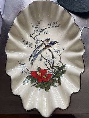 A Large Ceramic Shell-Form Platter with Polychrome Bird and Floral Decoration. A single 