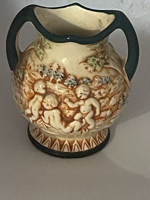 Japanese Majolica-Style Cherub Relief Two-Handled Miniature Vase. A single glazed earthenware 