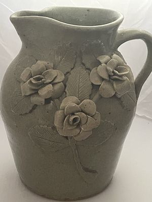 Michael Crocker & Pauline Crocker Stoneware Pitcher with High Relief Rose Decoration. A single 