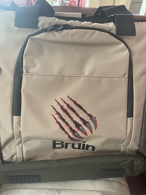 Bruin Branded Tan and Black Backpack Cooler. A single modern utility bag identified as a Bruin 
