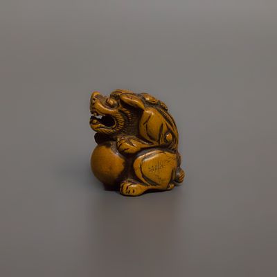 Нэцкэ &laquo;Карасиси с шаром тама&raquo;. Япония, 19 век. 
Дерево, резьба. 
Высота: 3,5 см. 
Подпись 