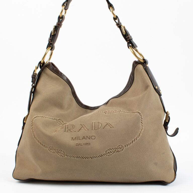 Prada Shoulder Bag. This Prada bag is a roomy shoulder bag . It is made of beige canvas and 