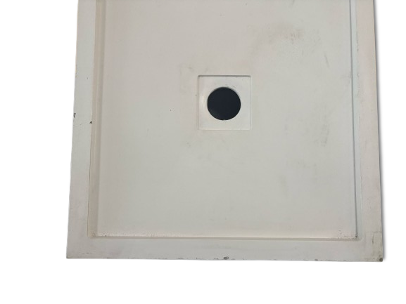 Shower Base. White shower base with hole for the siphon and recess for the drain.
