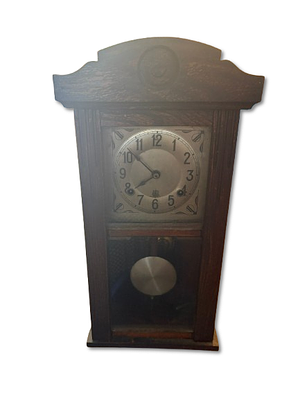 Wall Clock. Chestnut wood wall clock with pendulum. Signs of use.