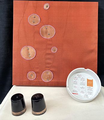 Decorative Items. Set consisting of one decorative frame in natural silk, one ceramic ashtray 