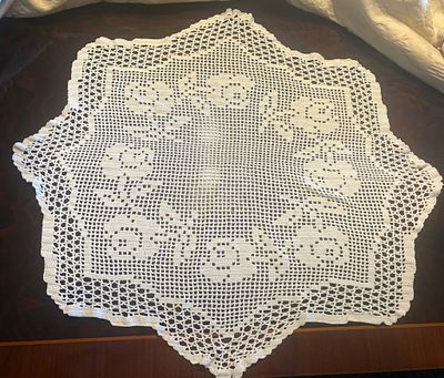 Lace Cloth. Handmade lace cloth in a circular shape. Signs of use.