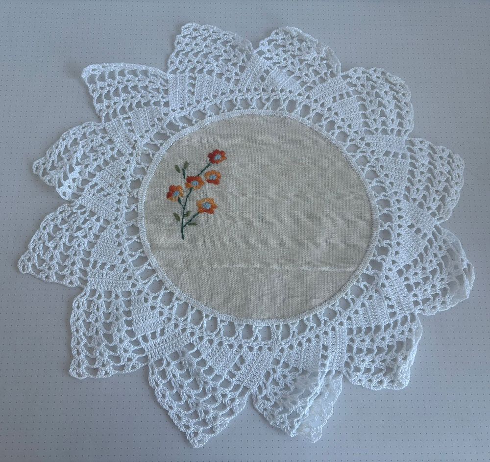 Linen and Lace Fabric. Linen cloth with hand-embroidered lace and embroidery. Circular shape. 