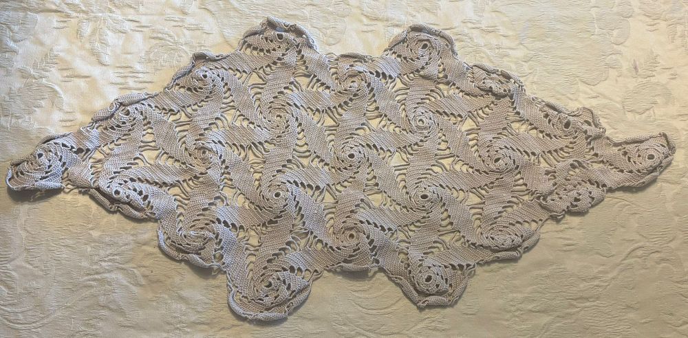 Lace Cloth. Handmade lace cloth in an oval shape. Signs of use.