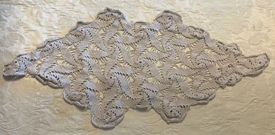 Lace Cloth. Handmade lace cloth in an oval shape. Signs of use.