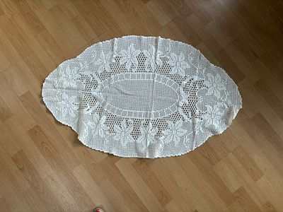 Lace Center Piece. Oval-shaped lace centerpiece with floral design. Signs of use.
