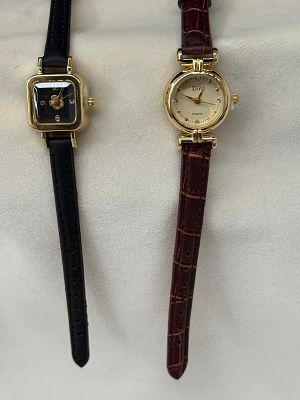 Vintage watches, one in black and the other in brown. Signs of use.