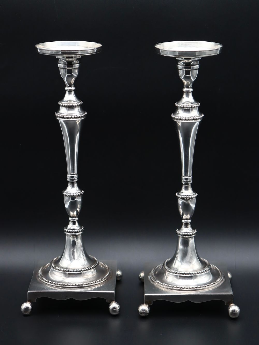 Pair of Portuguese Silver Candlesticks "1.&ordm; T&iacute;tulo". Plain decoration with beaded friezes. 