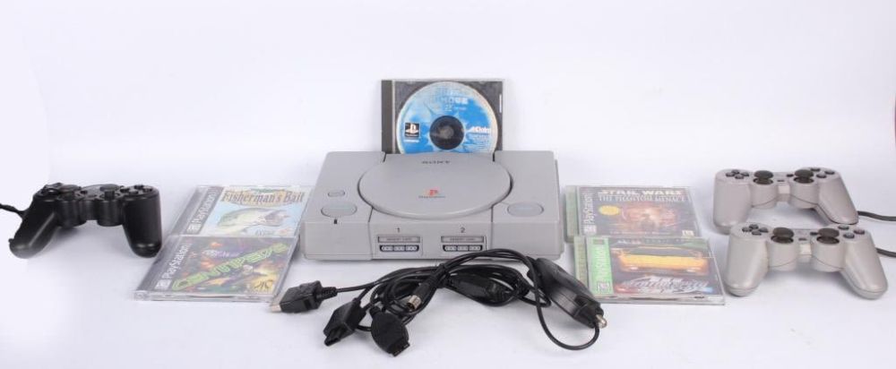 Lot 124254: PLAY STATION GAME SYSTEM W/ 5 GAMES & CONTROLLERS
