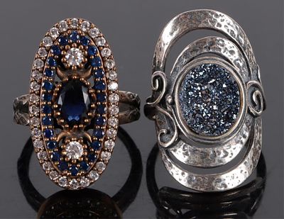 ORNATE STERLING SILVER BLUE STONE RING PAIR. Ornate sterling silver blue stone ring pair.Weight: 