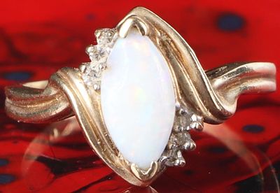 10K YELLOW GOLD LADIES RING W/ OPAL & DIAMONDS. 10k yellow gold ladies ring with an opal center 