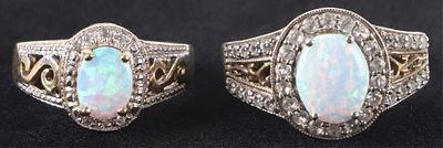 STERLING SILVER RINGS W/ OPAL & TOPAZ (2). Lot of two sterling silver rings with gold-tone 