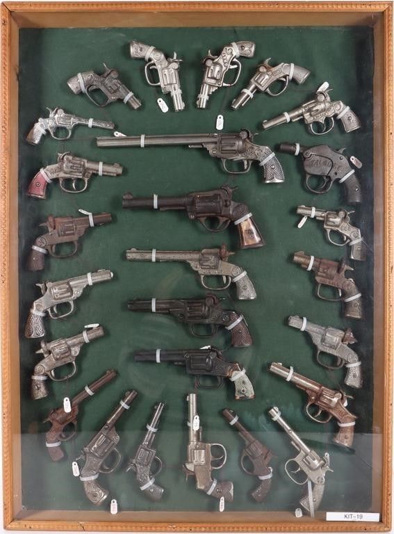 Lot 224415: VINTAGE ICONIC CAST IRON CAP GUNS FRAMED - (26)