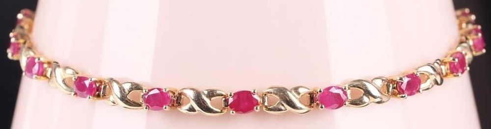 Lot 235276: 14K GOLD RUBY HUGS & KISSES LADIES TENNIS BRACELET