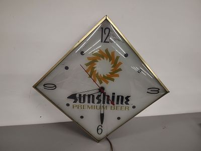 Beer clock. Sunshine Premium clock lights up and works small crack at the 9 light flaking 