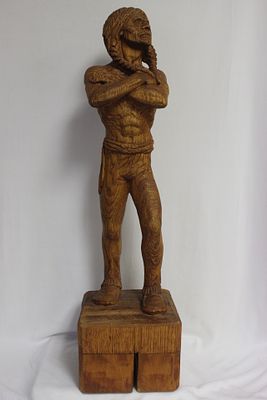 A Wood Statue of a Native American Man. carved from a single piece of wood - signed and dated - 