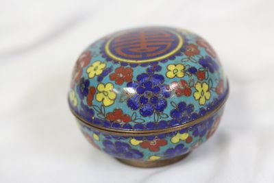 An Antique Chinese Cloisonne Box. 2 5/8" in diameter - please note: loss underneath the lid as shown