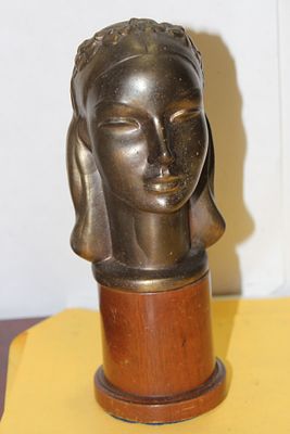 A Metal Bust on a Wood Stand. 8 1/2" tall