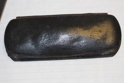 An Antique Metal and Cloth Glass Case. as shown