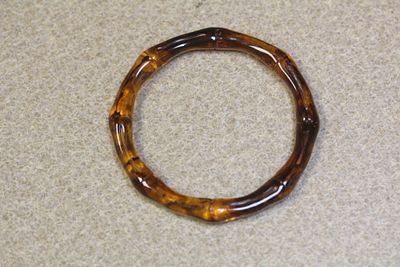 Lucite Bangle Bracelet. amber style bamboo motief - inside diameter= 2 1/2" - swirl design