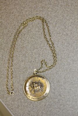 Medal pendant. bronze, with metal chain, overall 13 3/4" in length when clapsed