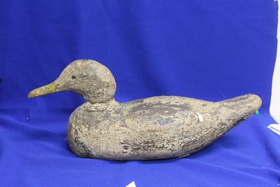 An Antique Wooden Duck Decoy. Traces of paint still visible - please note: one glass eye is 