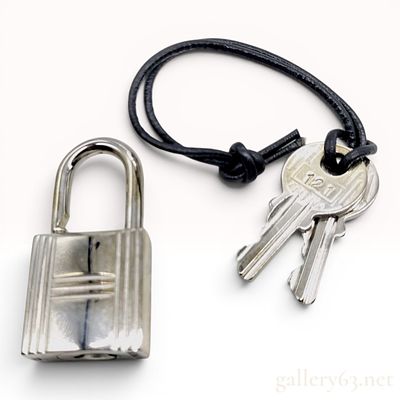 Hermes Silver-Tone Padlock and Key Set No. 121. An authentic Hermes Cadena padlock and matching 
