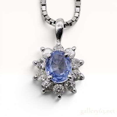 Platinum Tanzanite and Diamond Cluster Pendant Necklace. This platinum pendant necklace features 