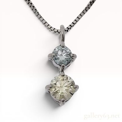 18K White Gold Two-Stone Blue and Yellow Diamond Pendant Necklace. A vertical two-stone drop 