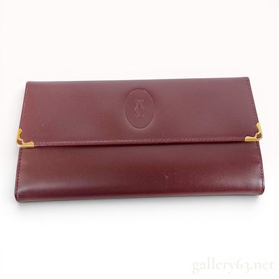 Must de Cartier Burgundy Leather Long Trifold Wallet. This Must de Cartier long trifold wallet 