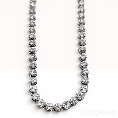 A Platinum and 10.00ctw Natural Diamond Graduated Tennis Necklace. This graduated diamond tennis 