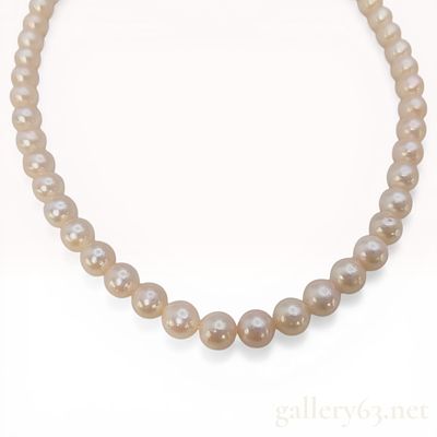 Cultured Freshwater Pearl Necklace with Silver Floral Clasp. A single strand of uniform round 