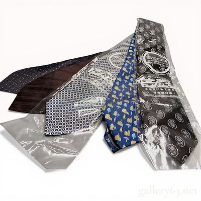 A Group of Five Designer Silk Neckties Including Salvatore Ferragamo, Hermes, and Yves Saint Laurent
