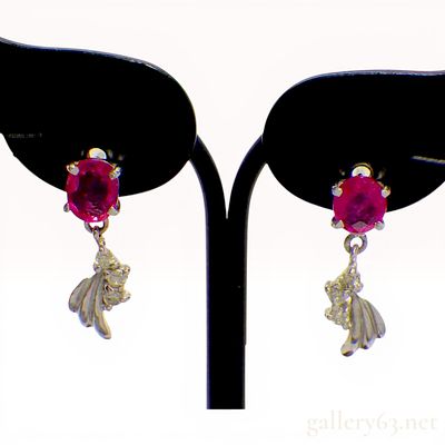 A Pair of 18K White Gold Ruby and Diamond Drop Earrings. A matched pair of 18K white gold drop 