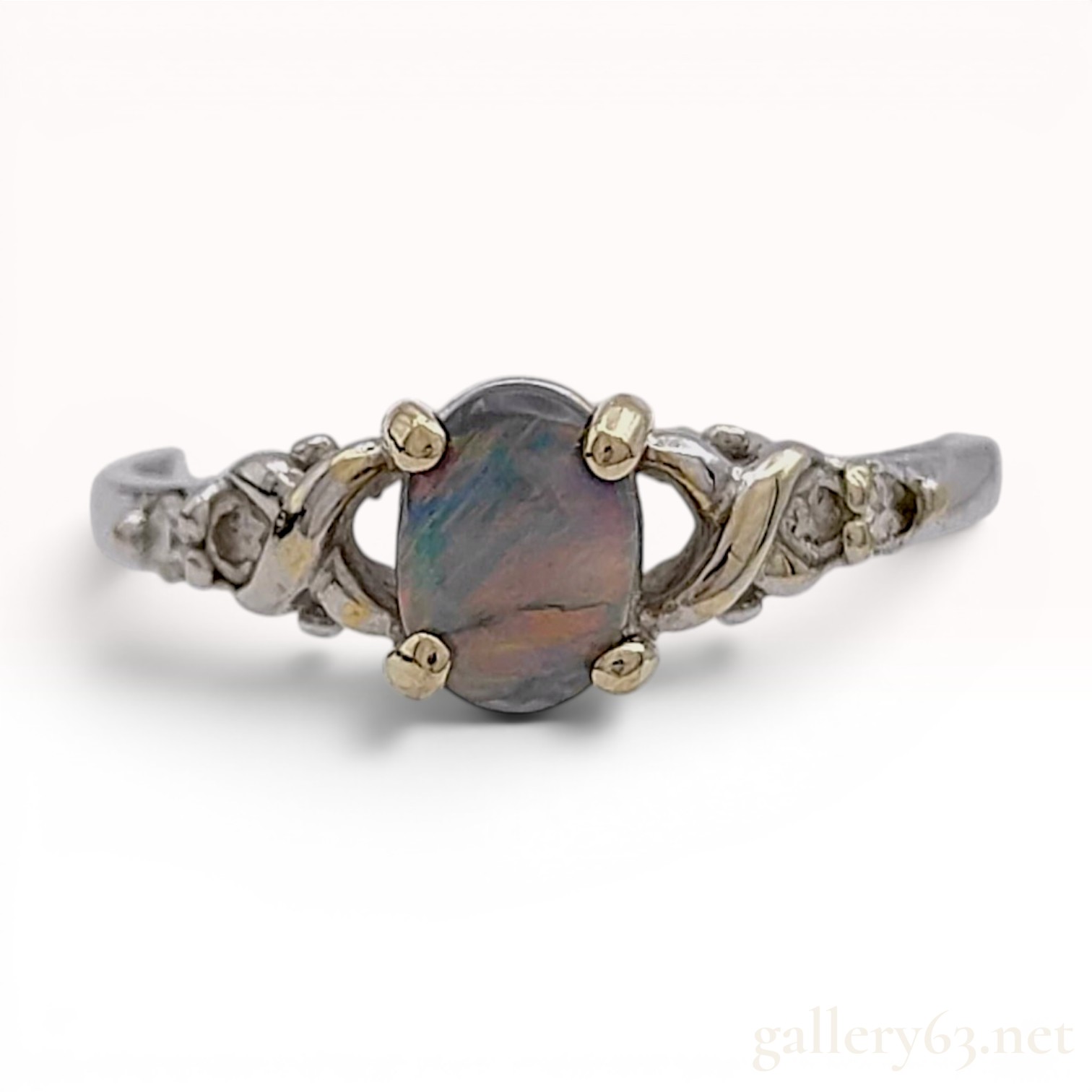 An 18 Karat Two-Tone Gold Black Opal and Diamond Ring