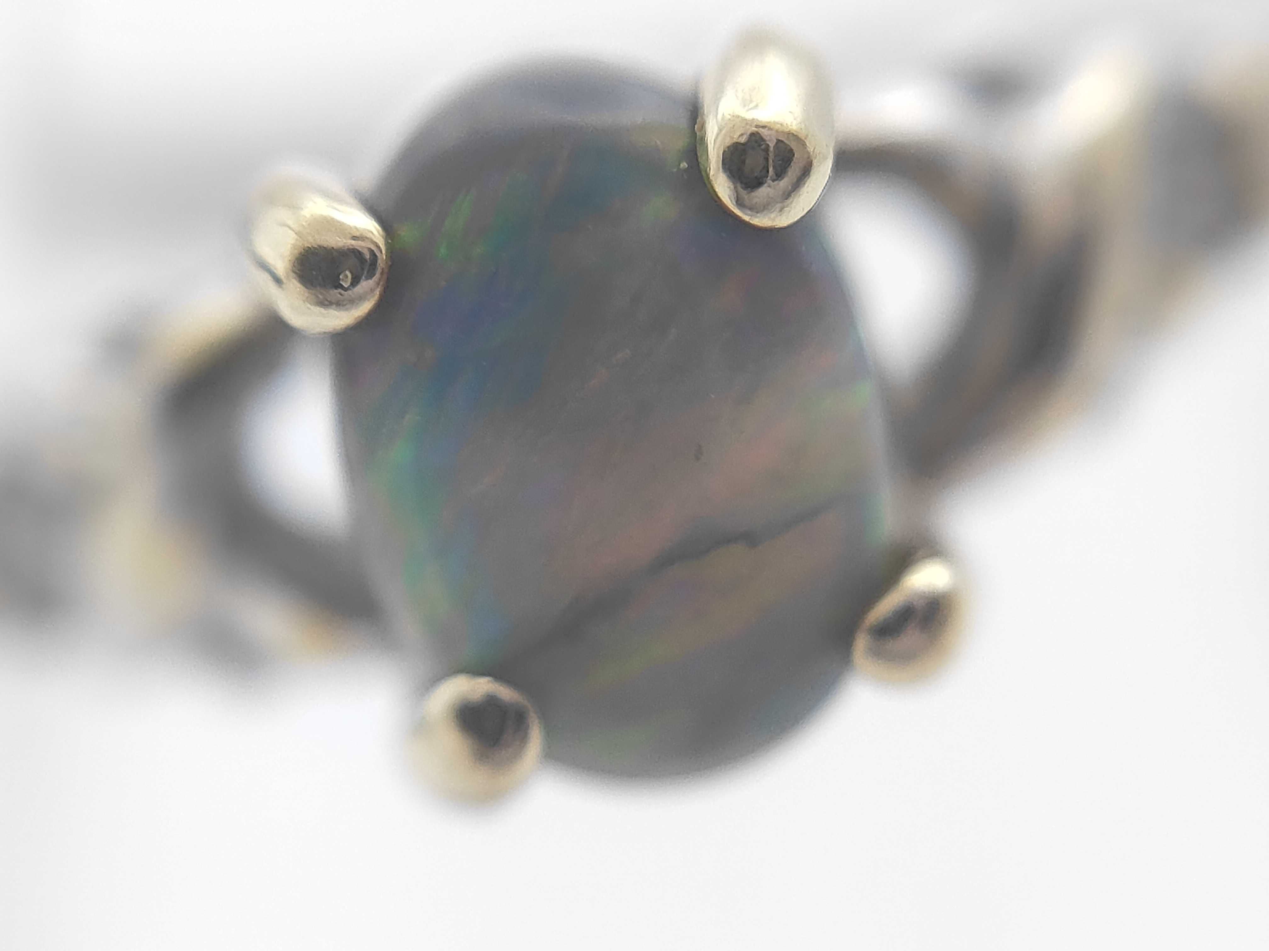 An 18 Karat Two-Tone Gold Black Opal and Diamond Ring