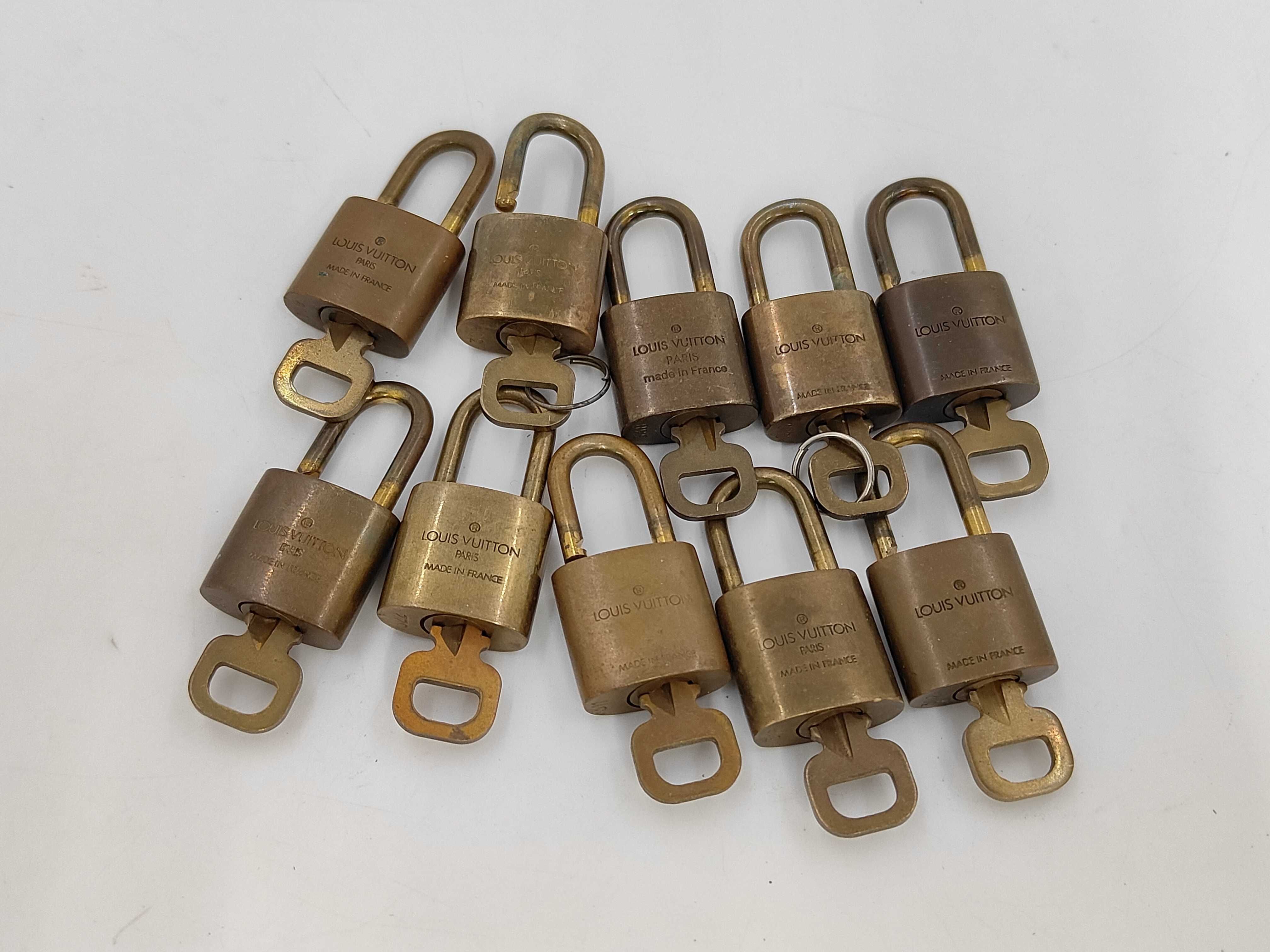 A Set of Ten Louis Vuitton Brass Padlocks and Keys