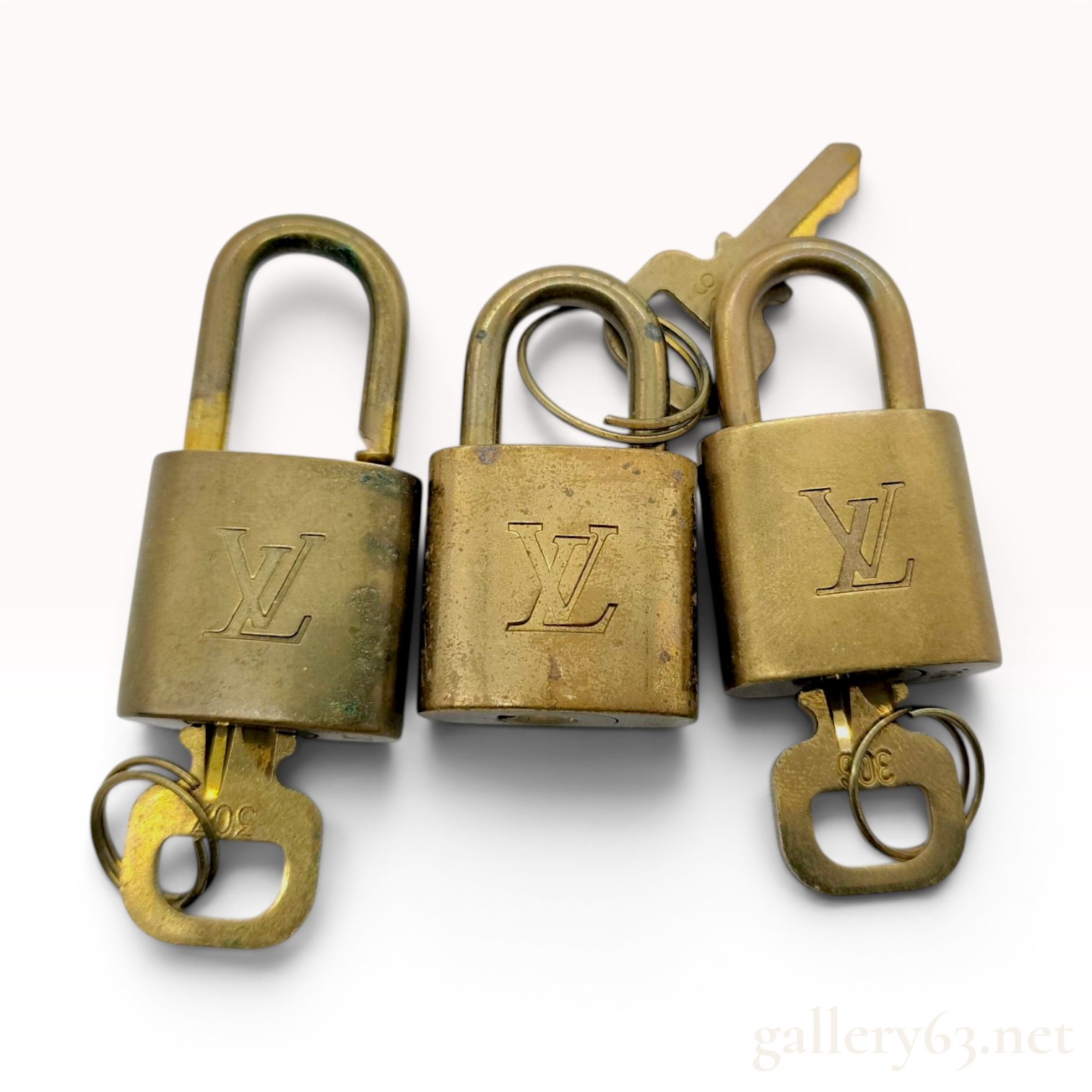 A Trio of Vintage Louis Vuitton Brass Luggage Padlocks with Matching Keys